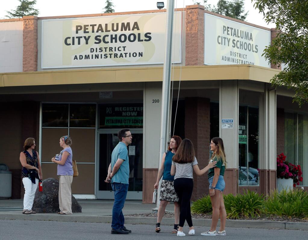 Community members talk with each other outside the Petaluma City Schools administration building after a board meeting. (Alvin Jornada / The Press Democrat, 2018)