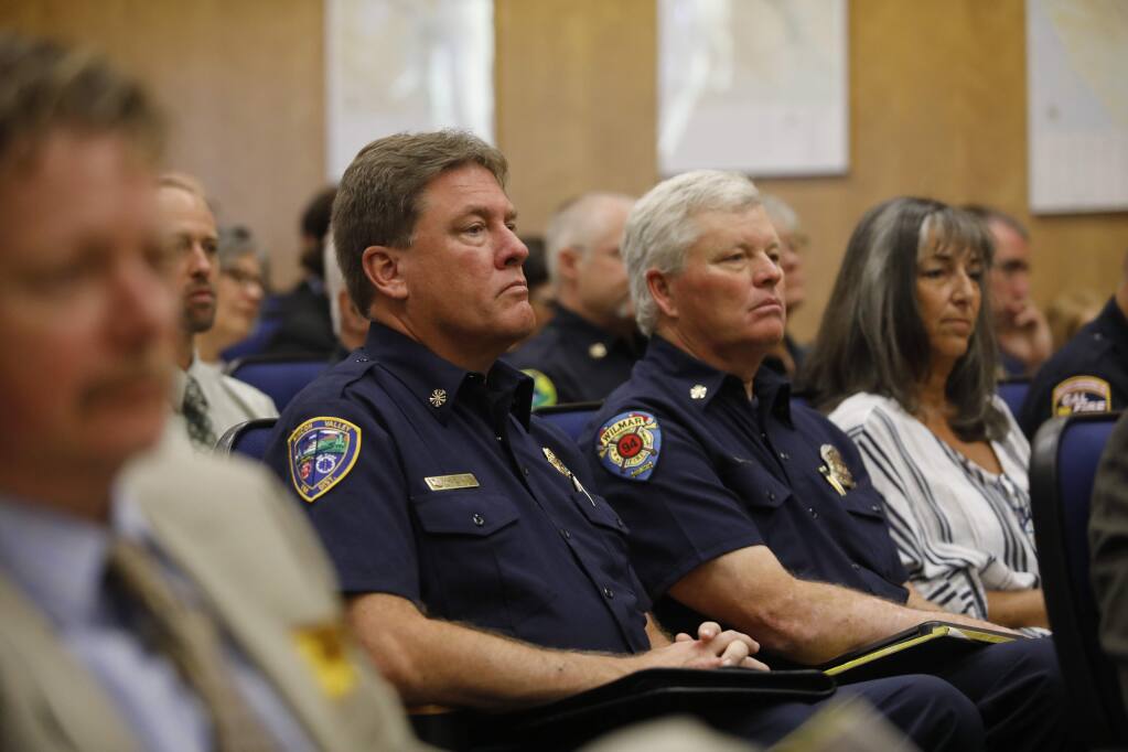 Mark Heine, Fire Chief of Rincon Valley and Windsor fire districts, and Mike Mickelson, right, Fire Chief of Wilmar Volunteer Fire Department attend the Sonoma County Board of Supervisors meeting in Santa Rosa on Monday, June 11, 2018. (Beth Schlanker/ The Press Democrat)