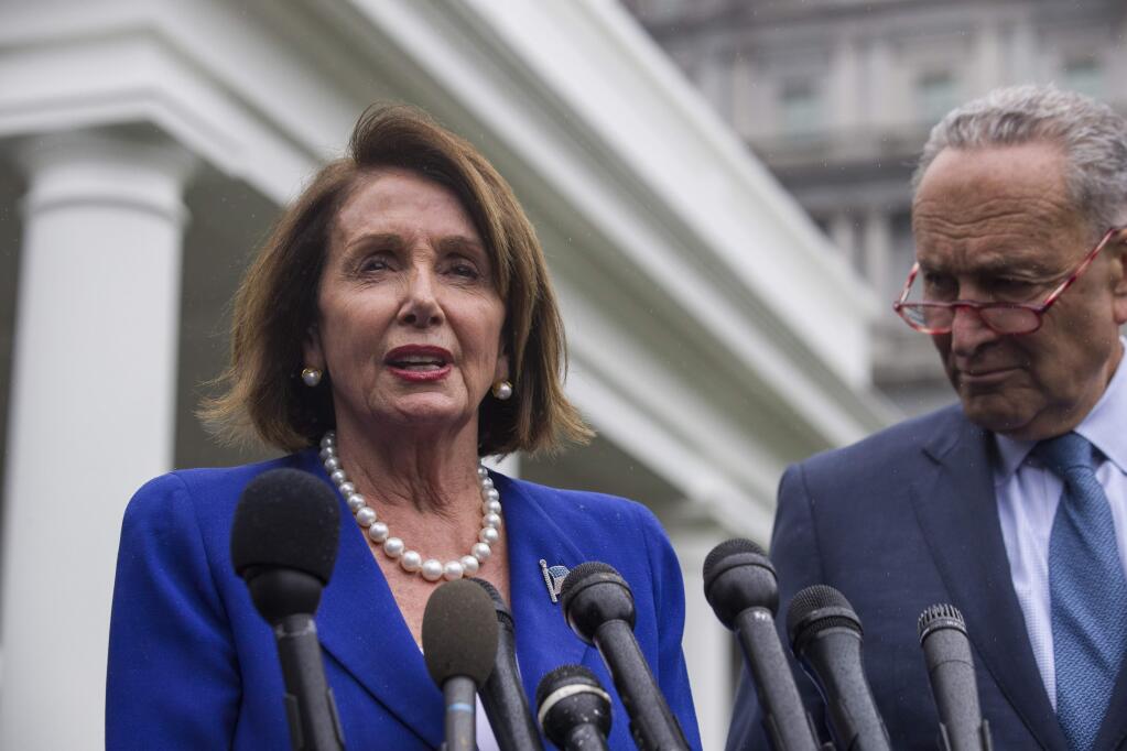 House Speaker Nancy Pelosi of Calif., left, and Senate Minority Leader Chuck Schumer of N.Y., speak with reporters after a meeting with President Donald Trump at the White House, Wednesday, Oct. 16, 2019, in Washington. (AP Photo/Alex Brandon)