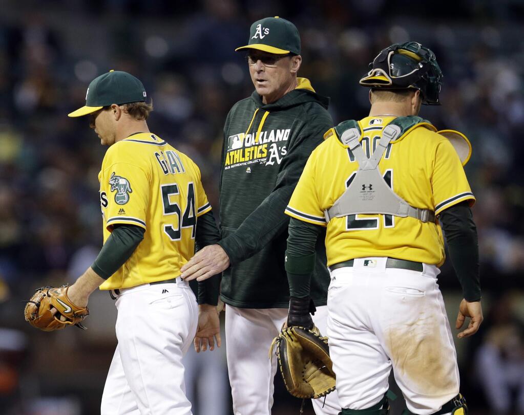 Oakland Athletics starter Sonny Gray, left, is pulled from the game by manager Bob Melvin, center, during the fourth inning against the New York Yankees on Friday, May 20, 2016, in Oakland. (AP Photo/Marcio Jose Sanchez)