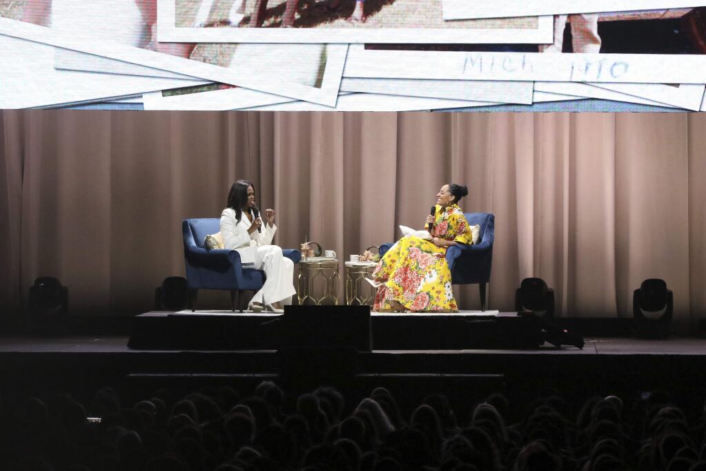 Former first lady Michelle Obama, left, and Tracee Ellis Ross speak at the 'Becoming: An Intimate Conversation with Michelle Obama' event at the Forum on Thursday, Nov. 15, 2018, in Inglewood, Calif. (Photo by Willy Sanjuan/Invision/AP)