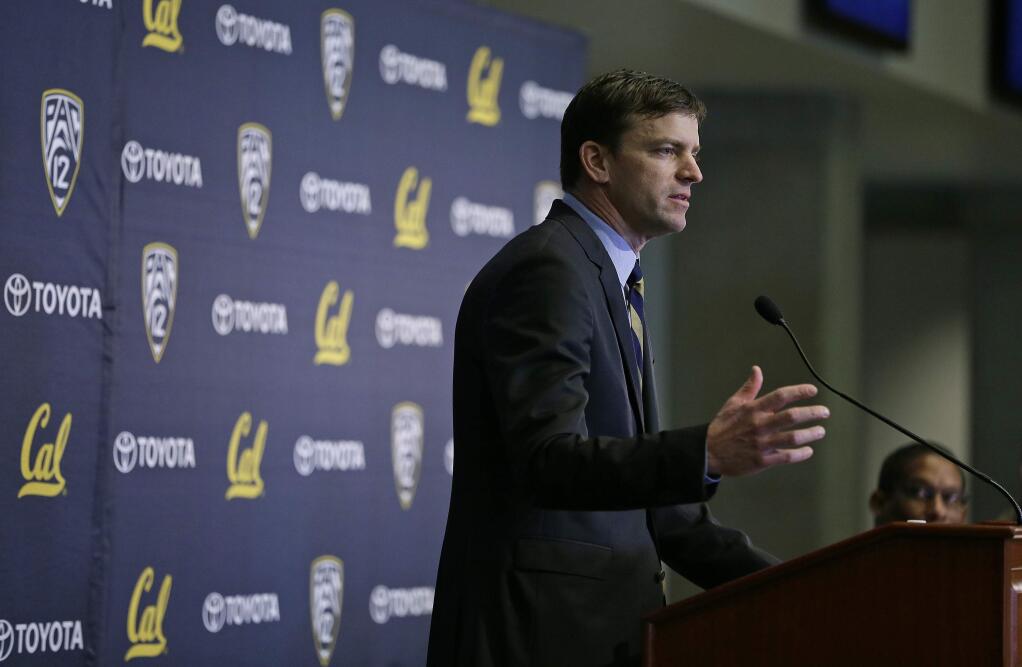 California head football coach Justin Wilcox, left, answers questions as Director of Athletics Mike Williams, right, listens during a news conference Tuesday, Jan. 17, 2017, in Berkeley, Calif. California officially introduced Wilcox, hoping the long-time defensive coordinator can help revive the struggling program. (AP Photo/Eric Risberg)