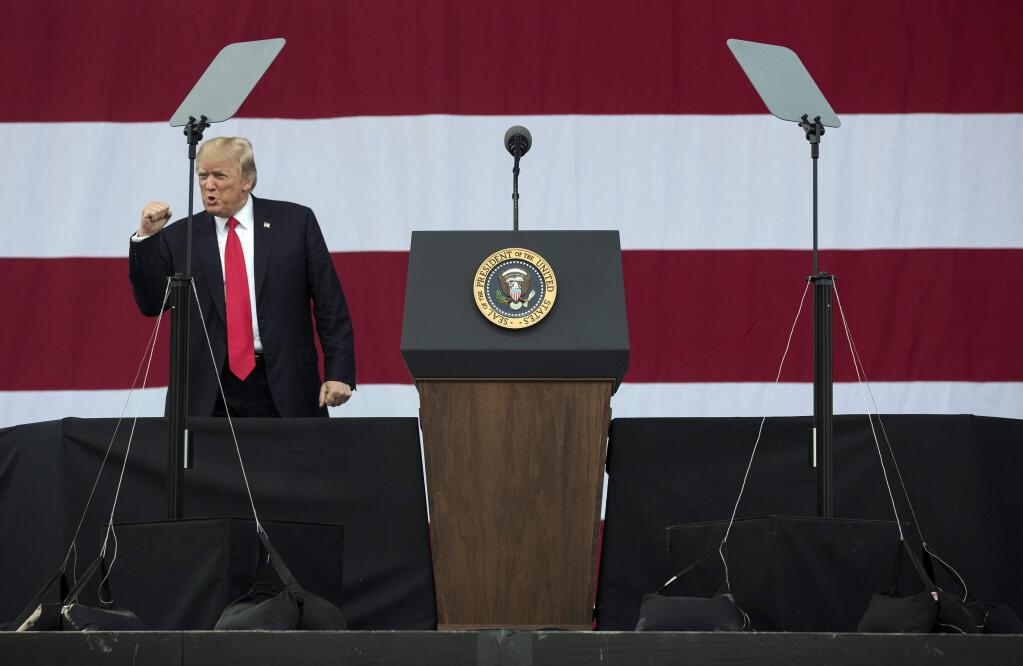 President Donald Trump pumps his fist as he arrives to speaks at the 2017 National Scout Jamboree in Glen Jean, W.Va., Monday, July 24, 2017. (AP Photo/Carolyn Kaster)
