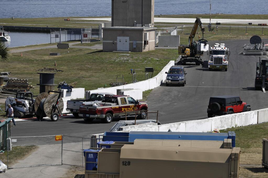 Worker begin to dismantle the track for the IndyCar Firestone Grand Prix of St. Petersburg, Monday, March 16, 2020, in St. Petersburg, Fla. Race organizers canceled the event to help curb the spread of the coronavirus. (AP Photo/Chris O'Meara)