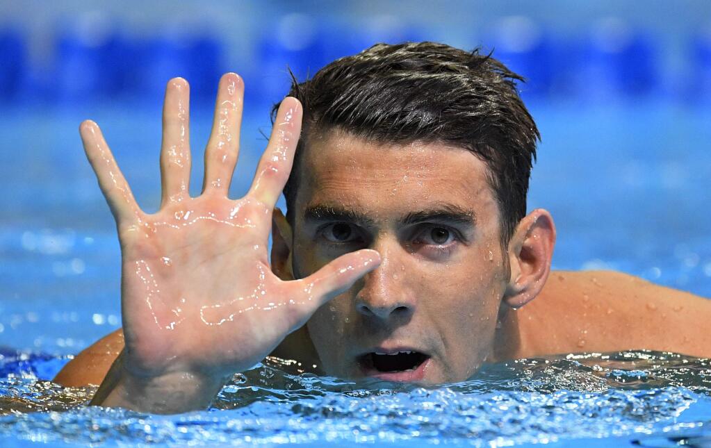 Michael Phelps gestures after winning the men's 200-meter butterfly at the U.S. Olympic swimming trials, Wednesday, June 29, 2016, in Omaha, Neb. Phelps qualified for his fifth Summer Games. (AP Photo/Mark J. Terrill)