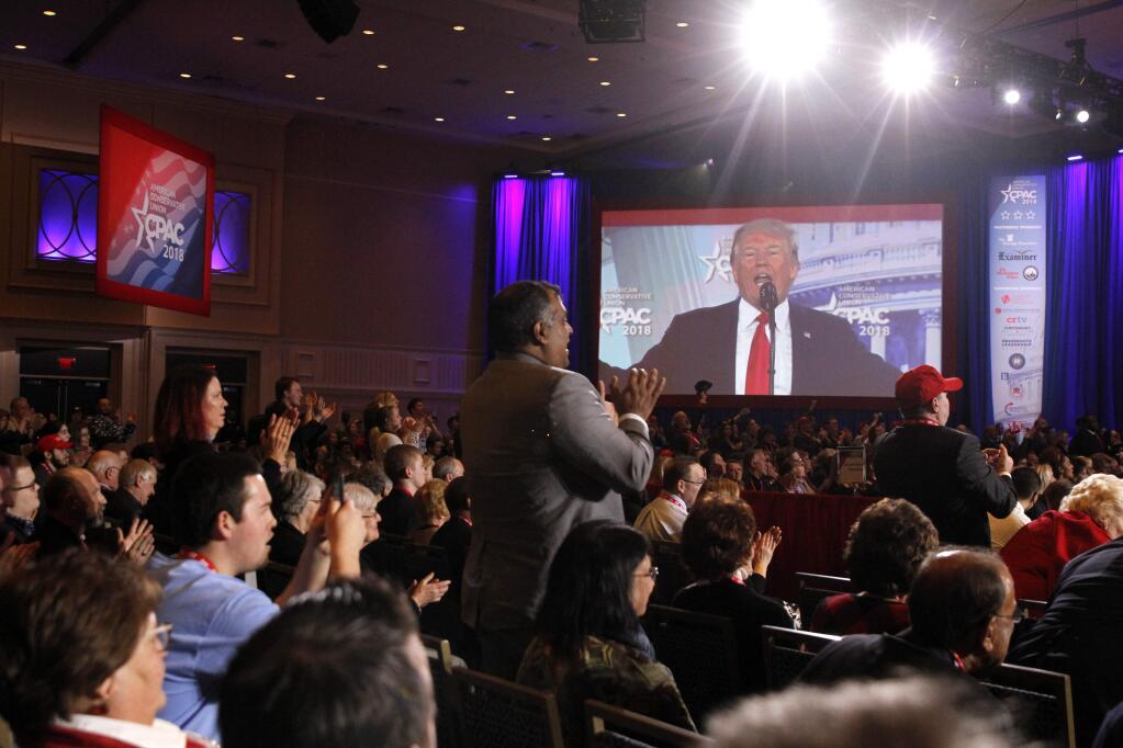Attendees applaud as President Donald Trump speaks to the Conservative Political Action Conference (CPAC), at National Harbor, Md., Friday, Feb. 23, 2018. (AP Photo/Jacquelyn Martin)