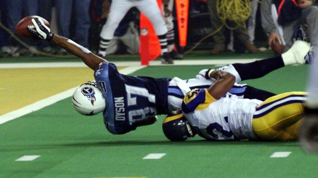 Tennessee Titans wide receiver Kevin Dyson tries but fails to get the ball into the end zone as he is tackled by the St. Louis Rams' Mike Jones on the final play of Super Bowl XXXIV in Atlanta in 2000. The Rams won 23-16. (AP Photo/John Gaps III)