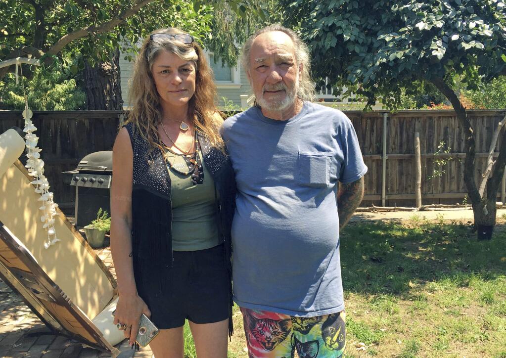 Heidi and Charles Lepp, who run the Sugarleaf Rastafarian Church, stand in the backyard of their Sacramento, Calif., home on Wednesday, Aug. 2, 2017. The Lepp's use cannabis as a sacrament in their religion. The shooting of two California deputies responding to a disturbance at the Rastafarian marijuana farm has drawn attention to religious use of the drug, sparking debate over whether churches should be protected from drug prosecutions. (AP Photo/Kathleen Ronayne)