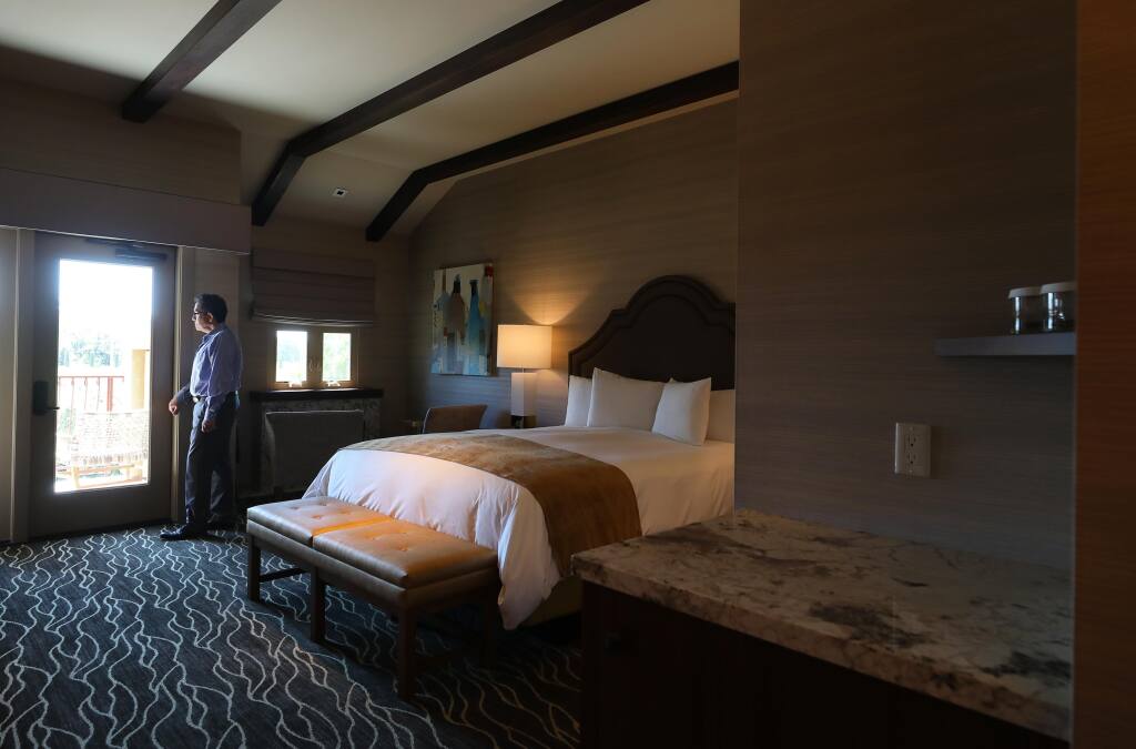 Vintners Resort general manager Percy Brandon stands in a guest room modified to reduce high touch objects for sanitary purposes, in Santa Rosa on Friday, June 26, 2020.  Decorative pillows, coffeemakers, and ice buckets have been removed from rooms, and are provided by bellhops upon request.(Christopher Chung/ The Press Democrat)