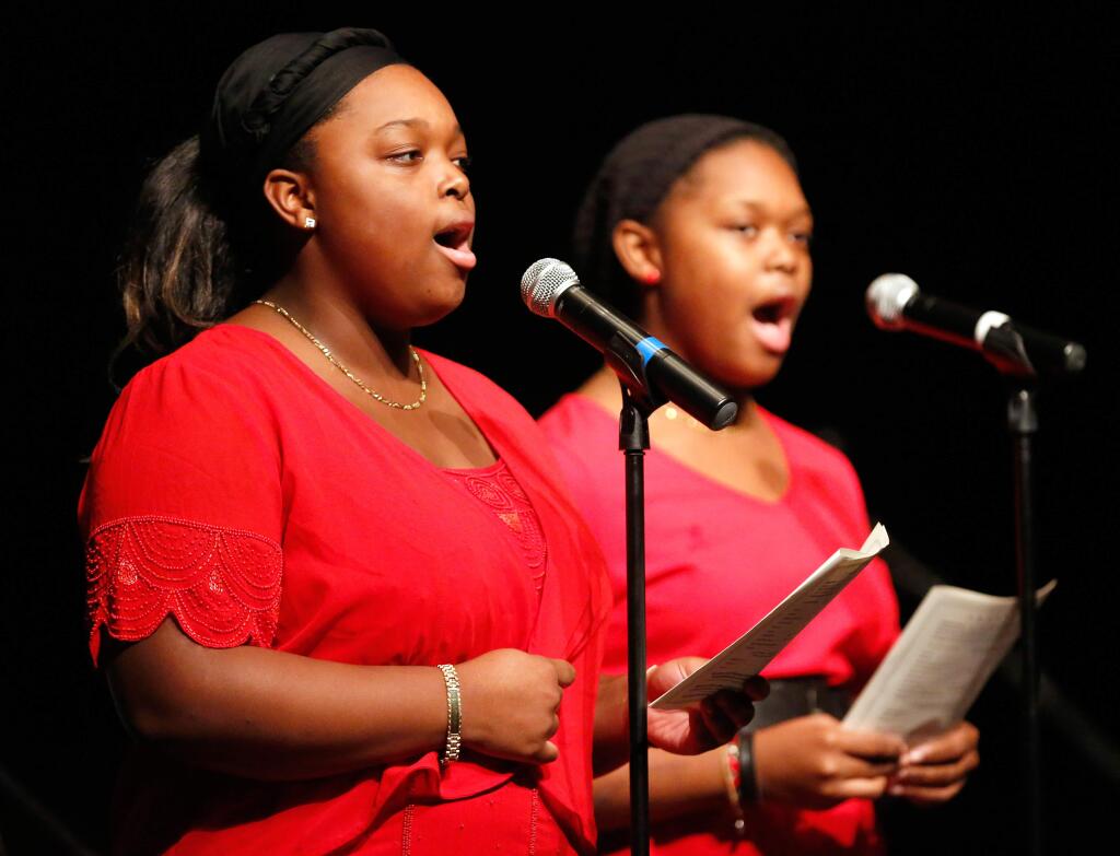 Sisters Keviette Minor, 16, and Cortunay Minor, 14 lead the audience in singing 'Lift Every Voice and Sing' during the annual Martin Luther King, Jr. birthday celebration in Santa Rosa on Sunday, Jan. 17, 2016. (Alvin Jornada / The Press Democrat)