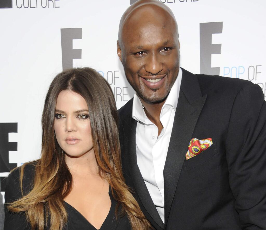 FILE - In this April 30, 2012, file photo, Khloe Kardashian Odom and Lamar Odom from the show 'Keeping Up With The Kardashians' attend an E! Network upfront in New York. Kardashian filed for divorce from Odom for the second time on Thursday, May 26, 2016, citing irreconcilable differences. The pair married in September 2009 and broke up in late 2013, but Kardashian withdrew her first divorce petition after Odom was found unconscious at a Nevada brothel last year and required serious medical treatment. (AP Photo/Evan Agostini, File)
