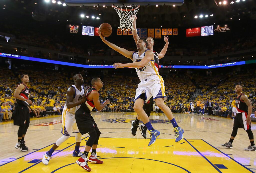 Golden State Warriors guard Klay Thompson goes to the basket against Portland Trail Blazers center Mason Plumlee during their game in Oakland on Sunday, May 1, 2016. The Warriors defeated the Trail Blazers 118-106. (Christopher Chung / The Press Democrat)