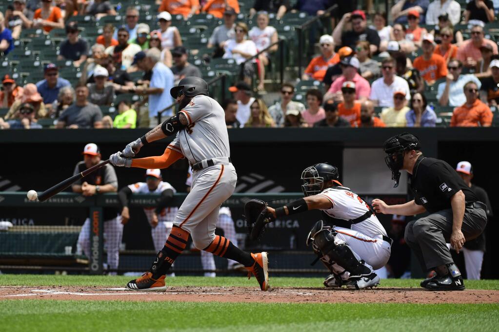 The San Francisco Giants' Kevin Pillar hits a RBI double in the fourth inning against the Baltimore Orioles, Sunday, June 2, 2019, in Baltimore. (AP Photo/Tommy Gilligan)