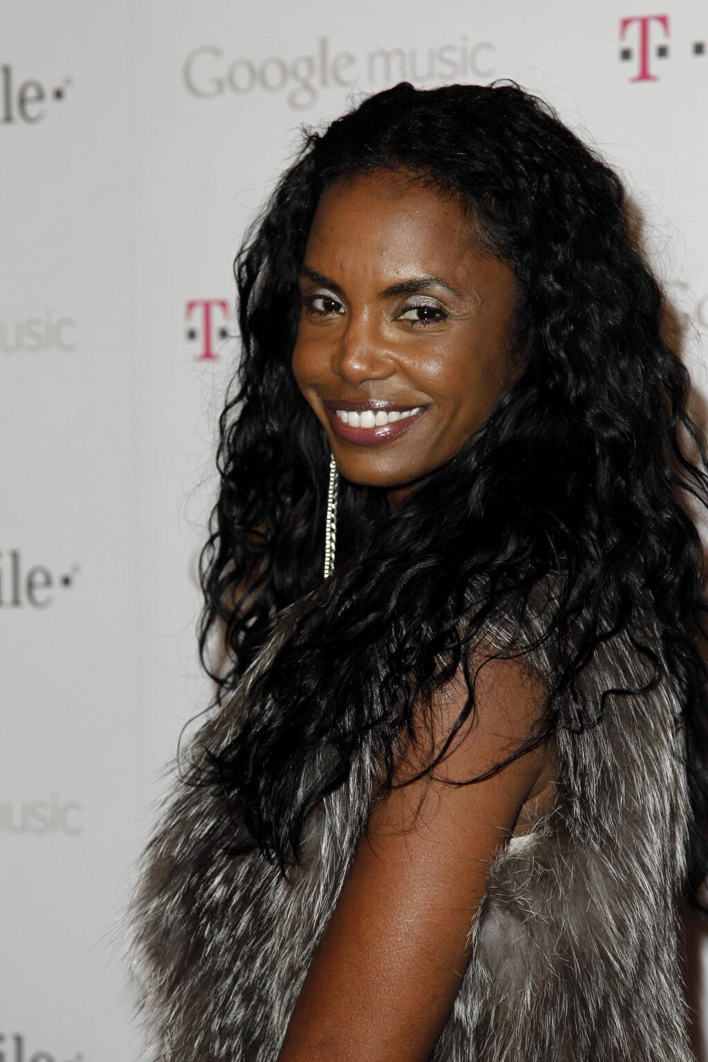 File-This Nov. 16, 2011, file photo shows Kim Porter arriving at the Google and T-Mobile party celebrating the launch of Google Music, in Los Angeles. Porter, Diddy's former longtime girlfriend and the mother of three of his children, has died. A representative for Sean 'Diddy' Combs confirmed the death of the 47-year-old on Thursday, Nov. 15, 2018. No further details were immediately available. (AP Photo/Matt Sayles, File)