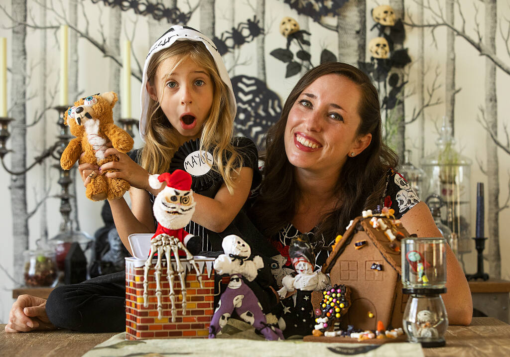 Caroline Hall, left, and her daughter Cecily Villeggiante, 5 of Petaluma with some of the fun crafts from her book “The Nightmare Before Christmas: The Official Cookbook & Entertaining Guide,” with crafts and recipes based on the movie. (John Burgess/The Press Democrat)