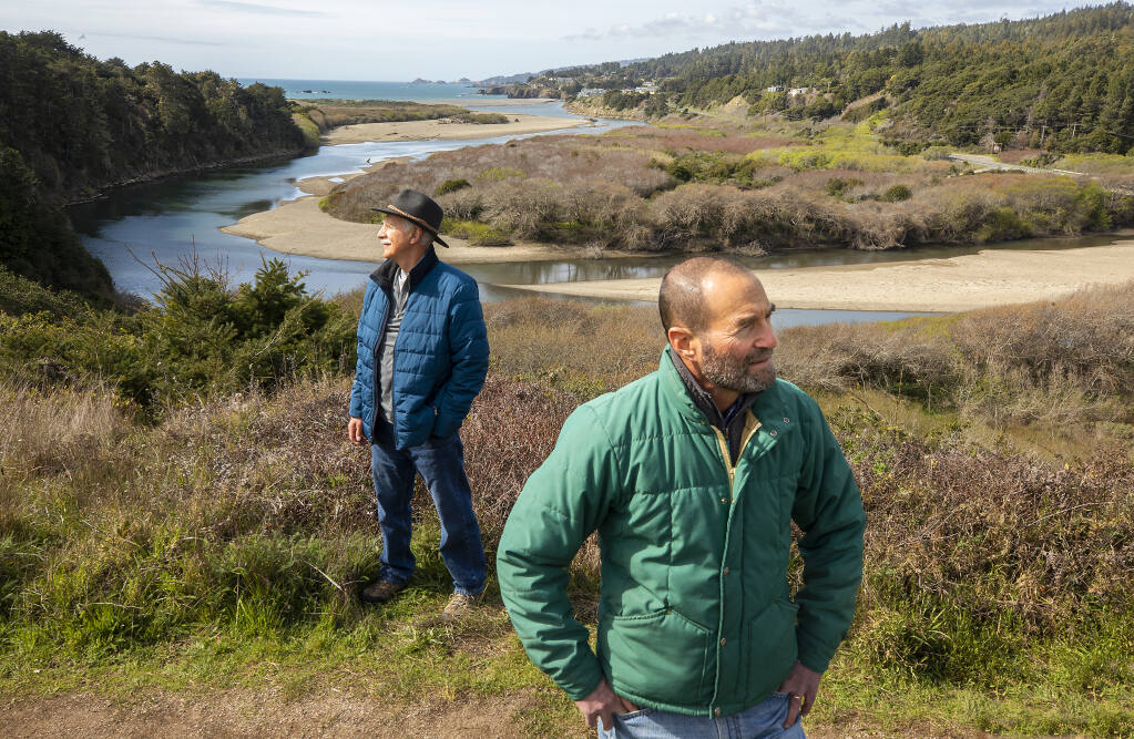 Dave Shpak, Mill Bend project manager, right, and John Walton, vice president of the Redwood Coast Land Conservancy board, stand on a bluff overlooking the mouth of the Gualala River and  the 113-acre Mill Bend Preserve recently acquired by the group on Wednesday, March 17, 2021.   (Photo by John Burgess/The Press Democrat)