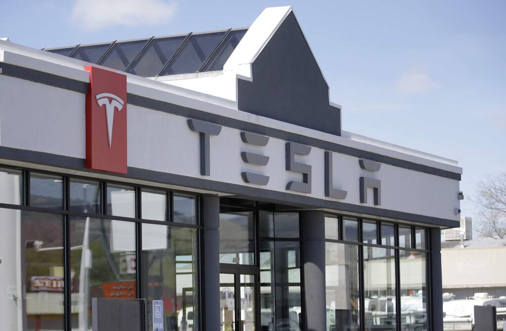 FILE - In this April 1, 2015, file photo, shows the Tesla Motors showroom in Salt Lake City. (AP Photo/Rick Bowmer, File)