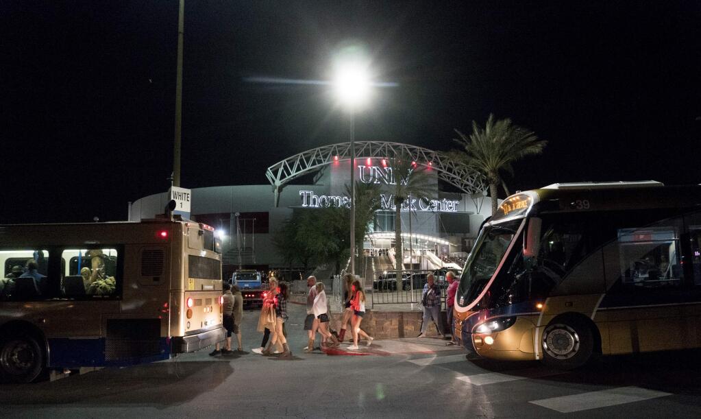 People load into buses destined to different Strip Casinos following a mass shooting at the Route 91 music festival along the Las Vegas Strip, Monday, Oct. 2, 2017. UNLV's Thomas & Mack Center was opened as a place of refuge. (Yasmina Chavez/Las Vegas Sun via AP)
