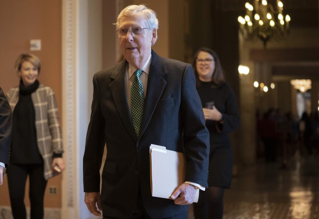 Senate Majority Leader Mitch McConnell, R-Ky., walks to the chamber as the Republican-led Senate is set to deal President Donald Trump a rebuke on his declaration of a national emergency at the Mexican border, with the only remaining question how many GOP senators will join Democrats in defying him, at the Capitol in Washington, Thursday, March 14, 2019. (AP Photo/J. Scott Applewhite)