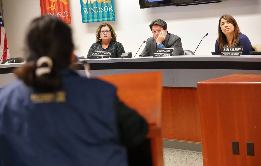 Debora Fudge, left, Dominic Foppoli, and Esther Lemus listen to comments from Rosa Reynoza during a Windsor Town Council meeting addressing voting districts in Windsor on Monday, Feb. 25, 2019. (Christopher Chung / The Press Democrat)