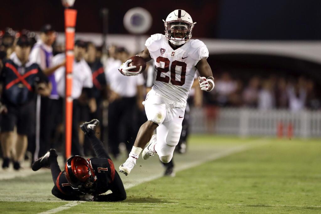 Stanford running back Bryce Love breaks away from San Diego State cornerback Kameron Kelly, on his way to scoring a touchdown during the second half of an NCAA college football game Saturday, Sept. 16, 2017, in San Diego. (AP Photo/Gregory Bull)