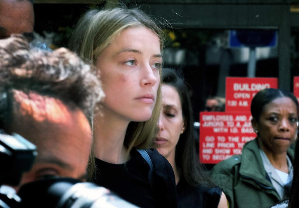 FILE - This May 27, 2016 file photo actress Amber Heard leaves Los Angeles Superior Court court, after giving a sworn declaration that her husband Johnny Depp threw her cellphone at her during a fight, striking her cheek and eye. Depp's estranged wife has given Los Angeles police a statement to support her account of an alleged domestic violence incident involving the actor, her lawyers said Tuesday, May 31. (AP Photo/Richard Vogel,File )