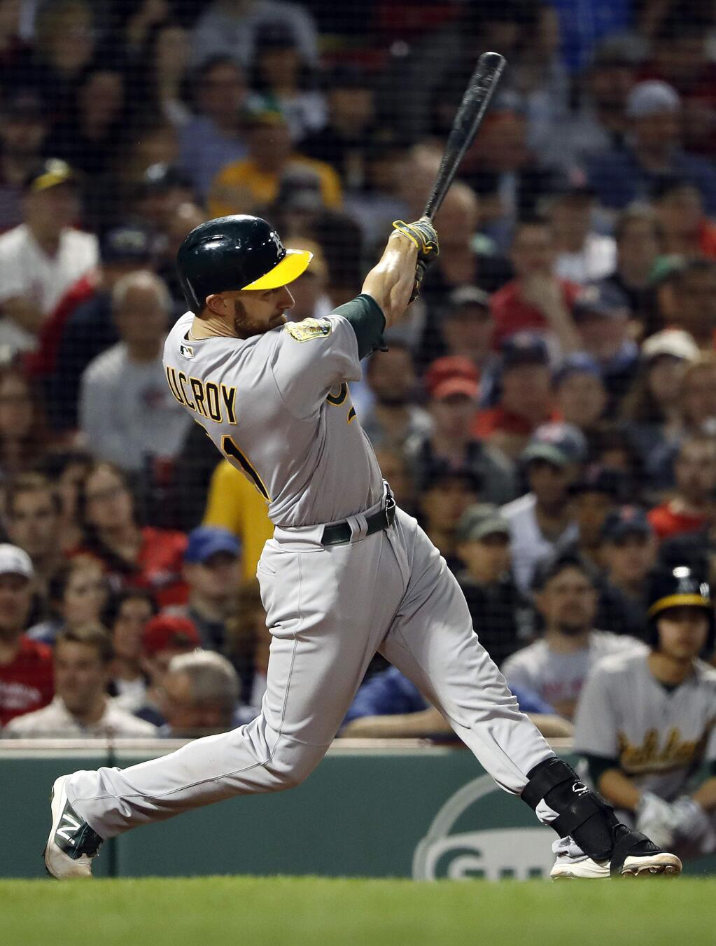 Oakland Athletics' Jonathan Lucroy follows through on a two-run double against the Boston Red Sox during the fourth inning of a baseball game at Fenway Park in Boston Monday, May 14, 2018. (AP Photo/Winslow Townson)