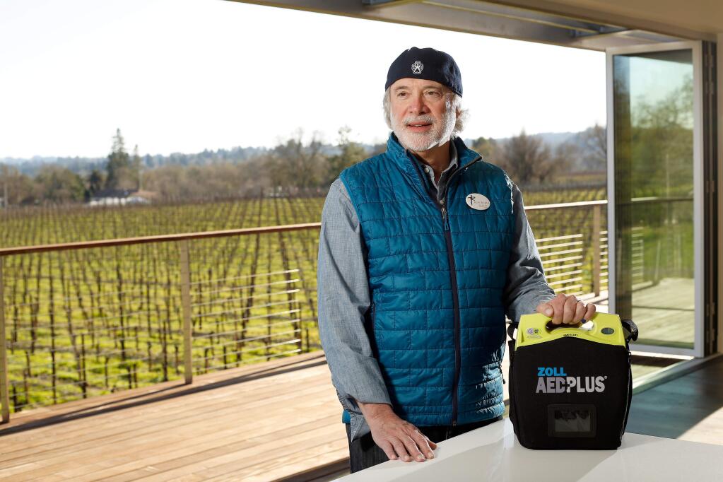 Vintner Ron Rubin, who had a defibrillator implanted, poses for a portrait with an automated external defibrillator at Ron Rubin Winery in Sebastopol, California, Tuesday, Feb. 13, 2018. Rubin wants to provide every winery in Sonoma County with an AED device. (Alvin Jornada / The Press Democrat)
