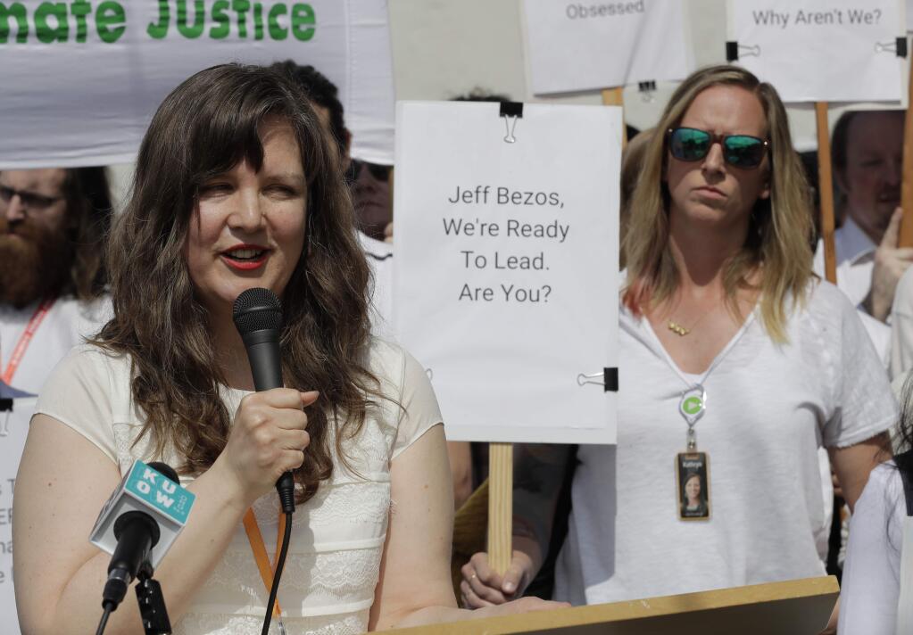 Emily Cunningham, left, who works as a user experience designer at Amazon.com, speaks as Kathryn Dellinger, right, who also works for Amazon, looks on, during a news conference following Amazon's annual shareholders meeting, Wednesday, May 22, 2019, in Seattle. Both women are part of the group 'Amazon Employees for Climate Justice.' (AP Photo/Ted S. Warren)