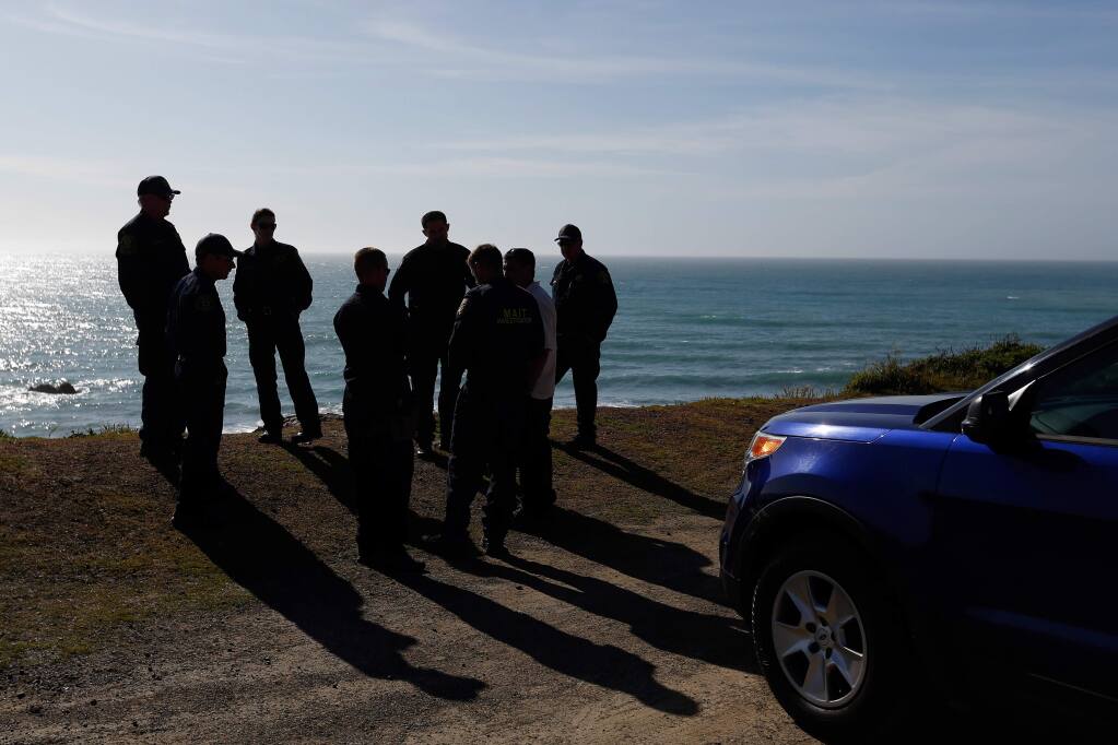 California Highway Patrol officers, deputy sheriffs from Mendocino and Alameda counties wrap up a search for three missing children, on Wednesday, March 28, 2018, at the site where the bodies of Jennifer Jean Hart, Sarah Margaret Hart and three of their adopted children were recovered two days earlier, after the family's SUV plunged over a cliff at a pullout on Highway 1, near Westport, California. (ALVIN JORNADA/ PD)