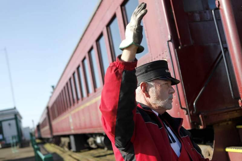 Skunk Train conductor Dennis Balassi directs the steam engine as it backs up to connect with the passenger cars at the depot on Thursday, Sept. 1, 2011, in Ft. Bragg, California. (BETH SCHLANKER/ The Press Democrat)