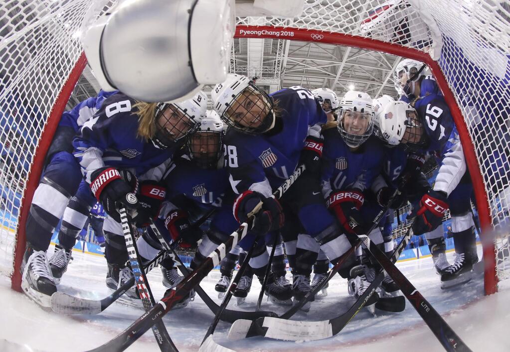 Players from the United States pose for the camera as they gather around the goal before the preliminary round of the women's hockey game against the team from Russia at the 2018 Winter Olympics in Gangneung, South Korea, Tuesday, Feb. 13, 2018. (Bruce Bennett/Pool Photo via AP)