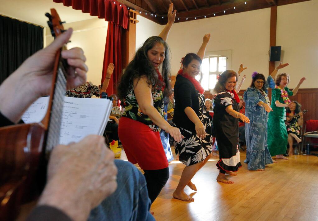 Women hula dance as other participants play ukuleles around them during the monthly Kanikapila Hawaiian music jam session and dance at Sonoma Valley Woman's Club in Sonoma, California on Saturday, January 28, 2017. (Alvin Jornada / The Press Democrat)