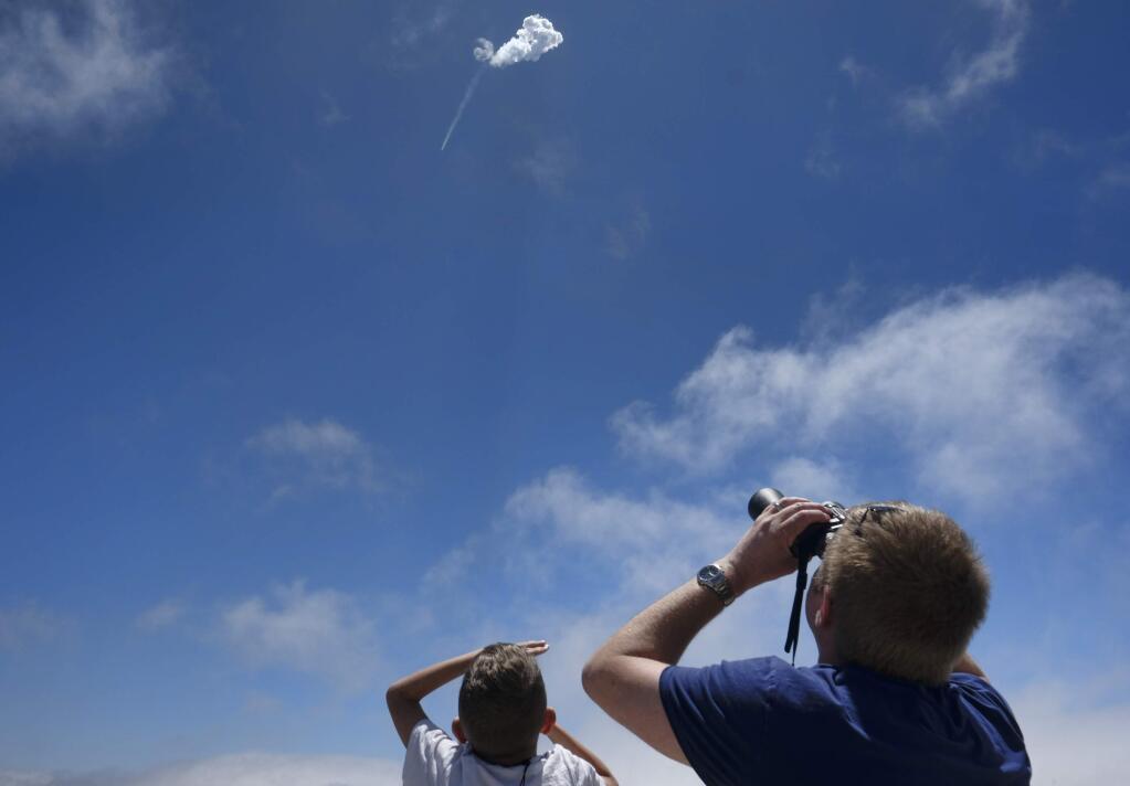 Spectators watch as a SpaceX Falcon 9 rocket heads skyward after being launched at the Vandenberg Air Force Base, Calif., on Sunday, June 25, 2017. SpaceX has succeeded in landing a Falcon 9 first-stage booster on a vessel in the Pacific after a launch from California. The rocket lifted off from Vandenberg Air Force Base Sunday, carrying 10 satellites for Iridium Communications. (AP Photo/Richard Vogel)