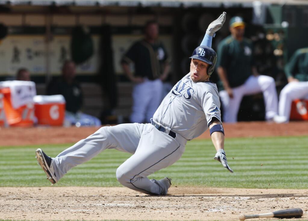 Tampa Bay Rays' Asdrubal Cabrera scores on an RBI single hit by Rene Rivera during the seventh inning of a baseball game against the Oakland Athletics, Sunday, Aug. 23, 2015, in Oakland, Calif. (AP Photo/Beck Diefenbach)