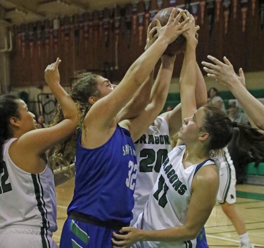 Bill Hoban/Special to the Index-TribuneSonoma's Sophie Lucchetti (#11) and Kennedy Midgley (#20) battle San Domenico's Siena Greenberg for a rebound during Friday night's game in the Dragon Classic. The Lady Dragons beat San Domenico, but lost to Drake and San Marin.