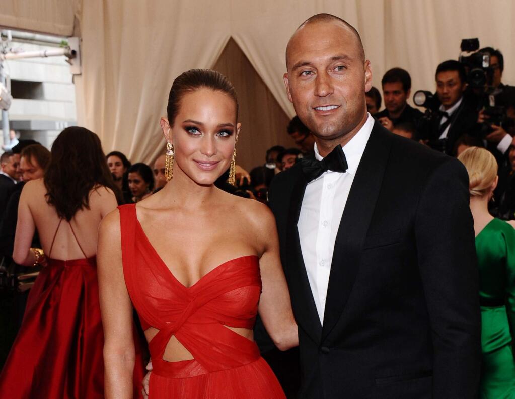FILE - In this May 4, 2015, file photo, Derek Jeter, right, and Hannah Davis arrive at The Metropolitan Museum of Art's Costume Institute benefit gala celebrating 'China: Through the Looking Glass' in New York. Derek Jeter has reportedly married his longtime girlfriend, Sports Illustrated swimsuit model Hannah Davis. TMZ and the New York Post have published photos of the weekend ceremony at the Meadowood resort in California's Napa Valley. (Photo by Charles Sykes/Invision/AP, File)