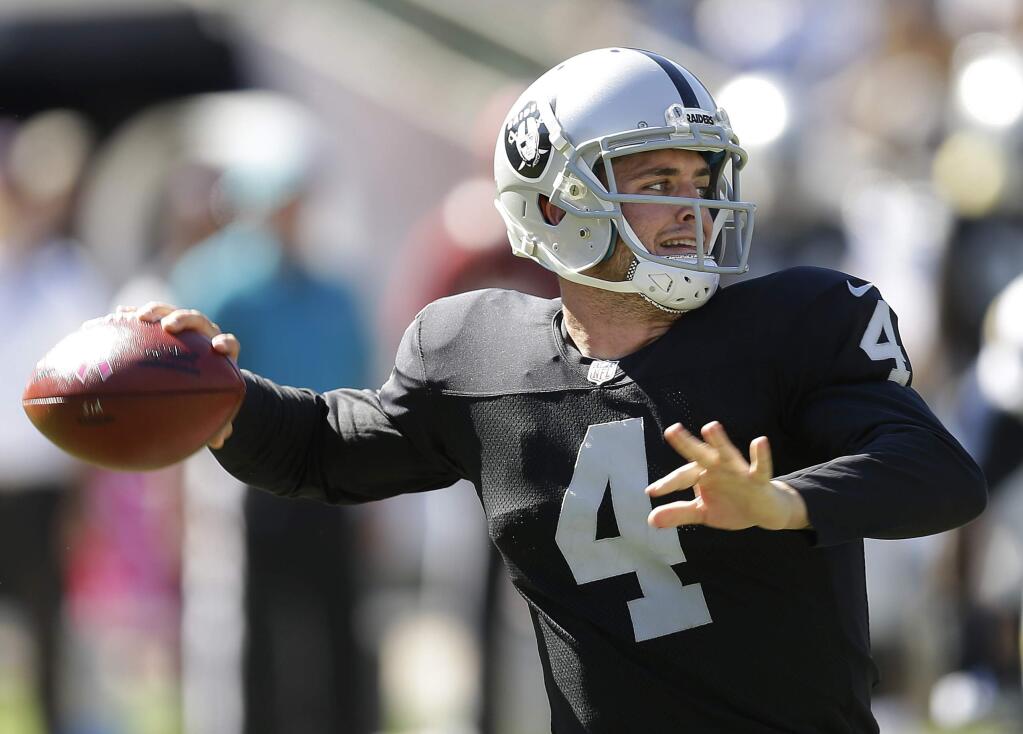 In this Oct. 12, 2014, file photo, Oakland Raiders quarterback Derek Carr passes against the San Diego Chargers during the second quarter of a game in Oakland. (AP Photo/Ben Margot, File)