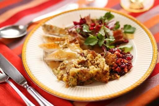 Jimtown chef Peter Brown's Thanksgiving day plate includes: Cider-brinded turkey with giblet gravy, Cranberry walnut relish with Grappa, Cornbread and sausage dressing, bitter greens with bacon pistachio and pomegranate vinaigrette. (Press Democrat)
