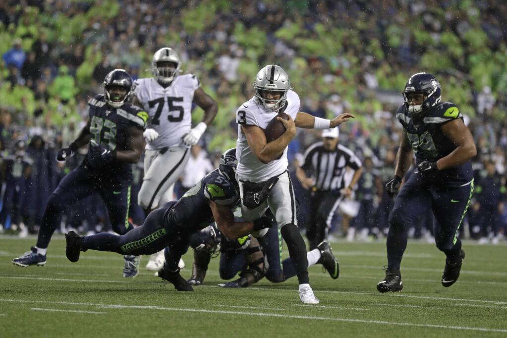 Oakland Raiders quarterback Nathan Peterman (3) scrambles, but Seattle Seahawks linebacker Cody Barton (57) makes the tackle during the first half of an NFL football preseason game Thursday, Aug. 29, 2019, in Seattle. (AP Photo/Stephen Brashear)