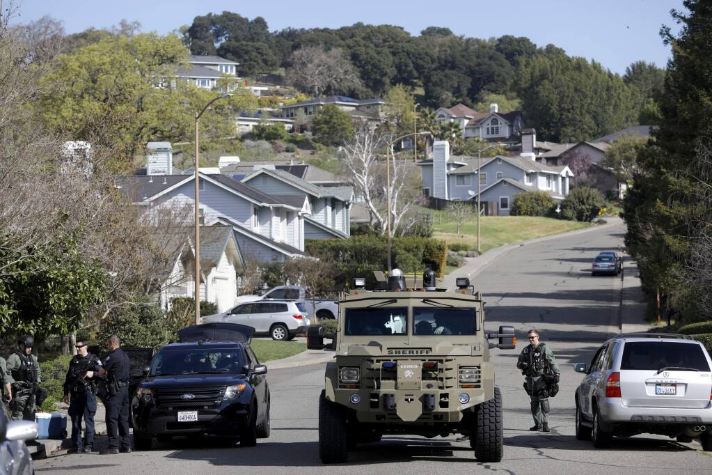 Area SWAT teams search a neighborhood in northern Novato for Petaluma home invasion suspects in a on Monday, March 12, 2018 in Novato, California . (BETH SCHLANKER/The Press Democrat)