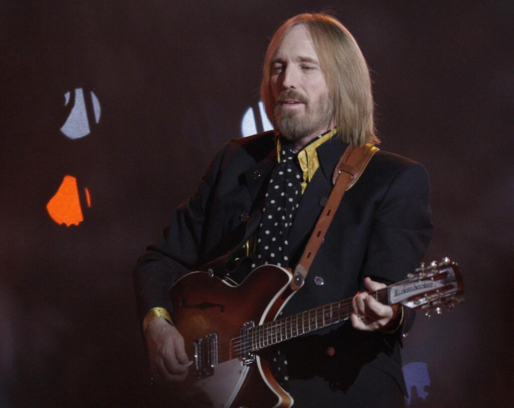 FILE - In this Sunday, Feb. 3, 2008 file photo, Tom Petty, of Tom Petty and the Heartbreakers, performs during halftime of the Super Bowl XLII football game between the New York Giants and the New England Patriots in Glendale, Ariz. Tom Petty's family says his death last year was due to an accidental drug overdose. His wife and daughter released the results of Petty's autopsy via a statement on his Facebook page Friday night, Jan. 19, 2018. (AP Photo/David J. Phillip, File)