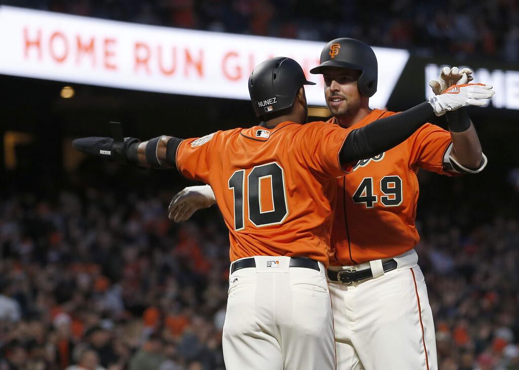 The San Francisco Giants' Chris Marrero (49) is congratulated by teammate Eduardo Nunez (10) after hitting a two-run home run during the second inning Friday, April 14, 2017, in San Francisco. (AP Photo/Tony Avelar)