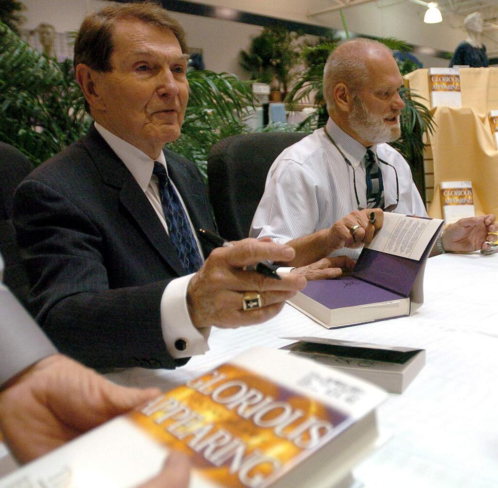 FILE - In an April 4, 2004 file photo, co-authors Tim Lahaye, left, and Jerry B. Jenkins sign copies of their newest book Glorious Appearing in Bossier City, La. LaHaye, the author of the multimillion best-selling ''Left Behind'' novels about the return of Jesus and the rapture, died Monday, July 25, 2016, in San Diego days after suffering a stroke, according to his publicist. He was 90 years old. (Shane Bevel/The ( Shreveport ) Times via AP, File)