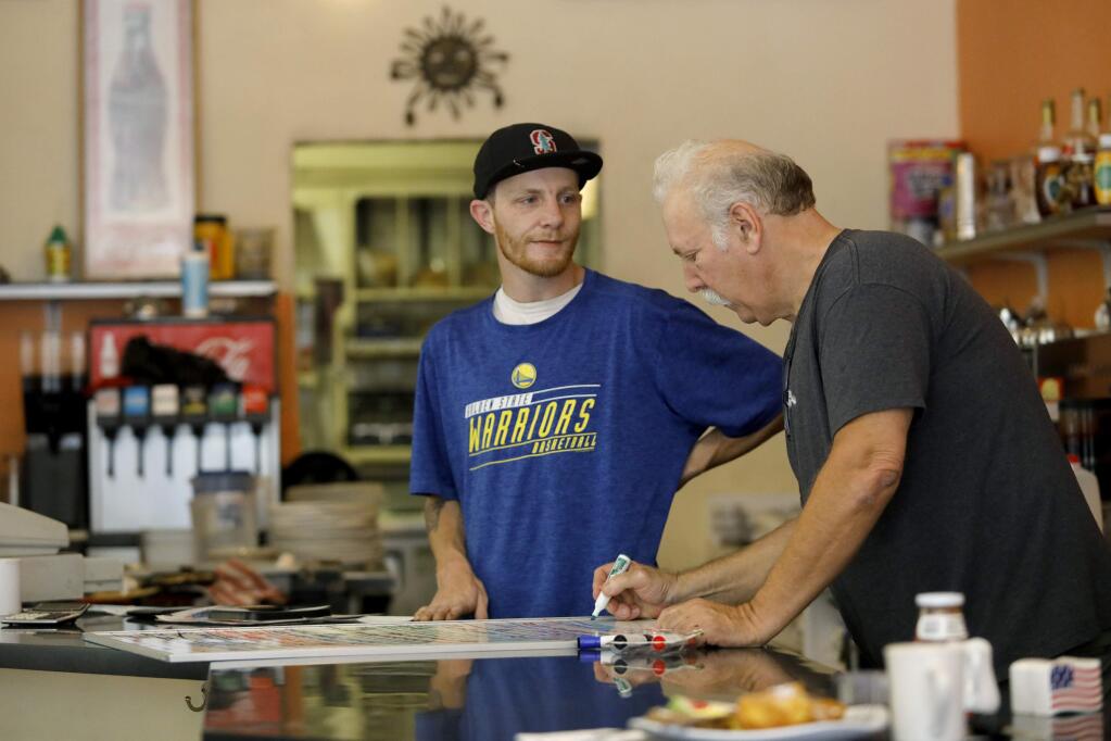 Mike Monahan, owner of Creekside Cafe, and his son Casey, work the lunch shift on Tuesday, June 12, 2018 in Sonoma, California . (BETH SCHLANKER/The Press Democrat)