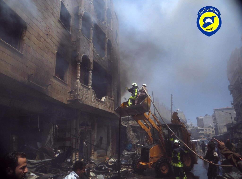 FILE - I n this Sunday, June. 12, 2016 file photo provided by the Syrian Civil Defence White Helmets, which has been authenticated based on its contents and other AP reporting, shows Civil Defense workers putting out a fire in a building following airstrikes hit a market area in Idlib, Syria. A Syrian volunteer search-and-rescue group has launched a campaign to win its first responders the 2016 Nobel Peace Prize. The Syrian Civil Defense, also known as the White Helmets, operate in the country's war-ravaged opposition areas, where they are exposed daily to bombs dropped by government and Russian warplanes. The group's global following say their task is 'the most dangerous job on the planet.' (Syrian Civil Defence White Helmets via AP, File)