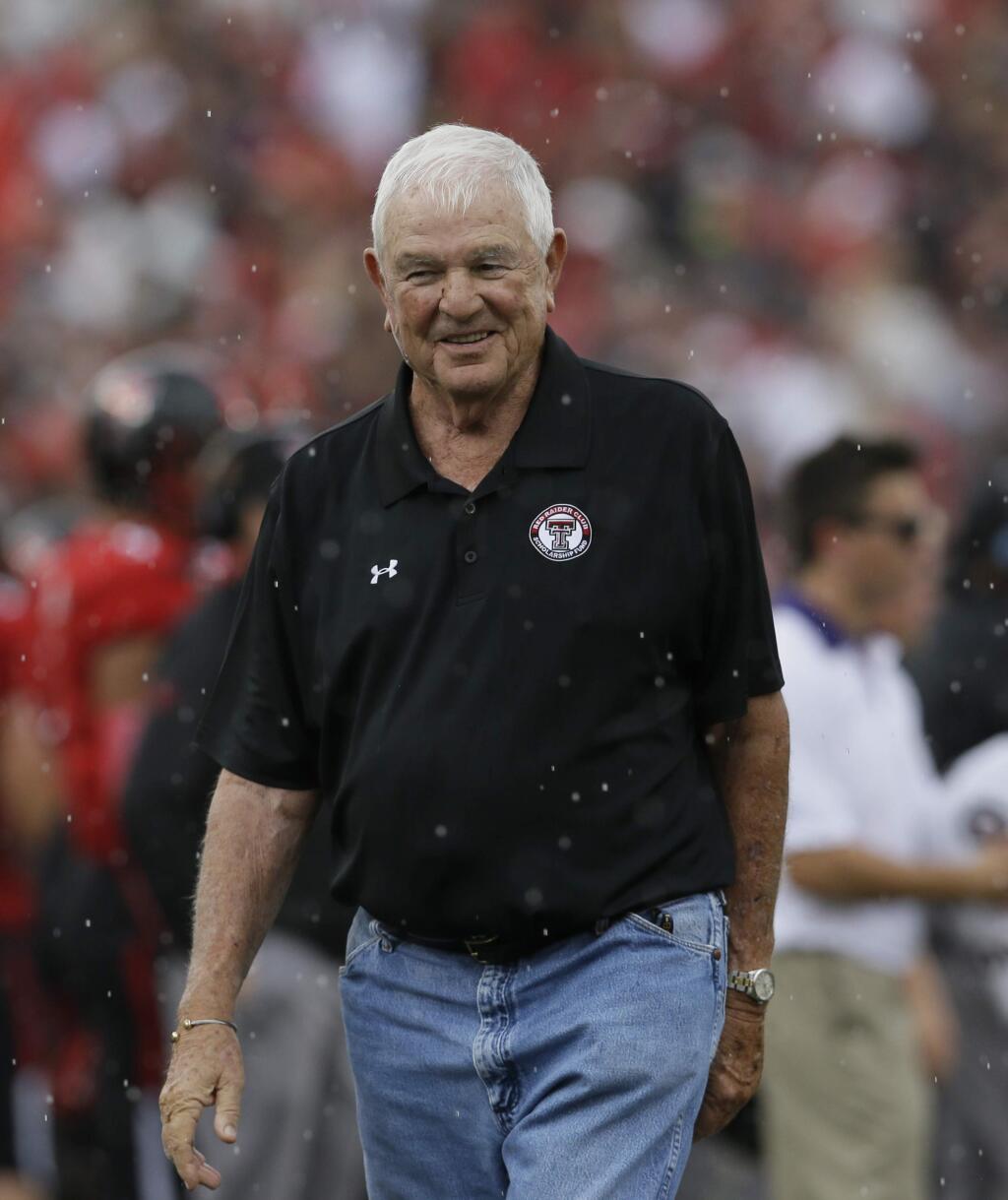 FILE - In this Sept. 26, 2015, file photo, former Texas Tech football coach Spike Dykes walks the field during the first half of an NCAA college football game in Lubbock, Texas. Dykes son, Sonny Dykes, is head coach for the California football team. (AP Photo/LM Otero, file)