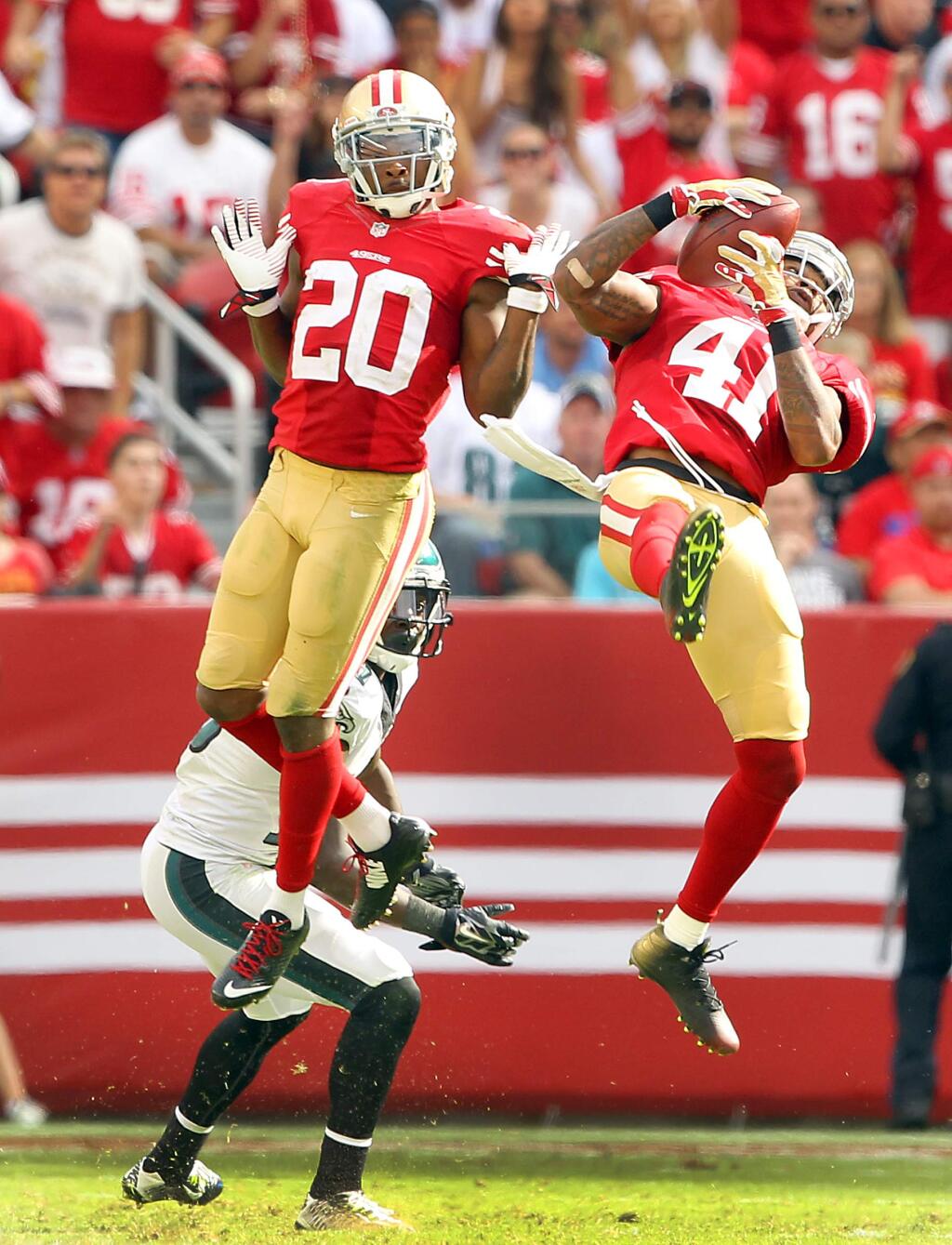 Antoine Bethea intercepts a Nick Foles pass in the 4th quarter while Perrish Cox avoids the collision. The 49ers beat the Eagles, 26-21, at Levi Stadium on Sunday, September 28, 2014.