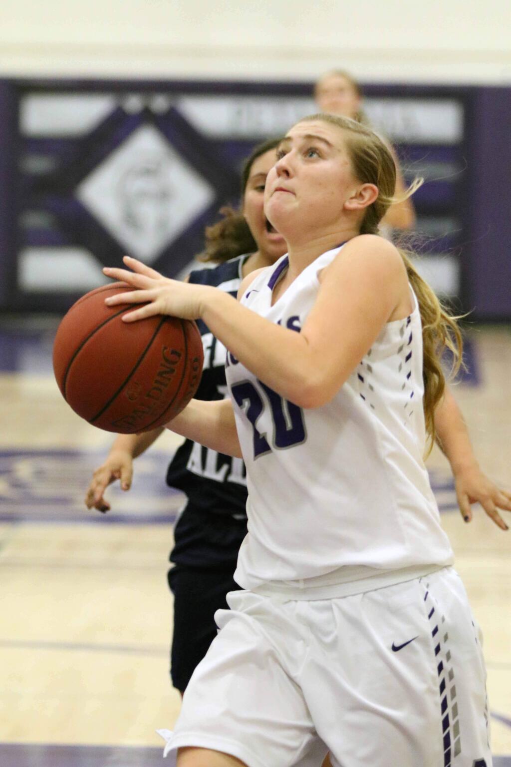 DWIGHT SUGIOKA/FOR THE ARGUS-COURIER Petaluma's Kailee Silacci takes the ball to the hoop against Elsie Allen. The senior was one of 10 T-Girls to score in a 53-12 victory.