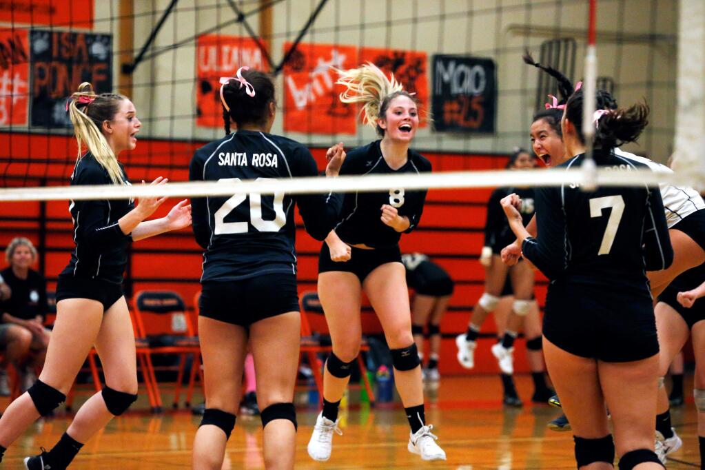 The Panthers celebrate a point during a varsity volleyball game between Cardinal Newman and Santa Rosa high schools on Tuesday, Oct. 9, 2018. (Alvin Jornada / The Press Democrat)